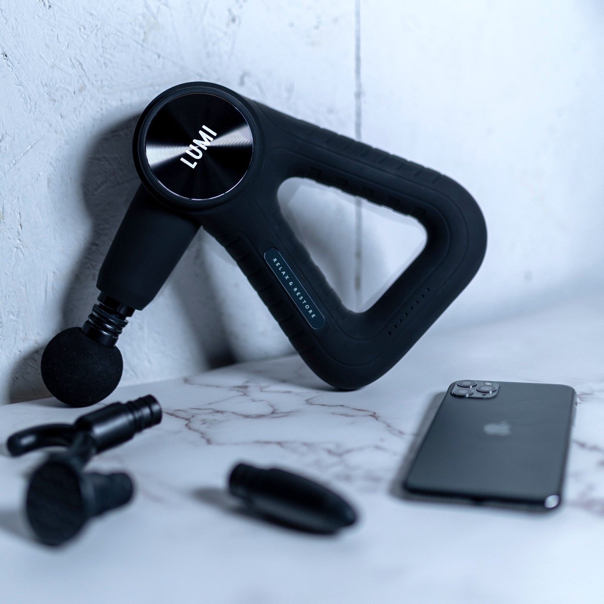 Lumi powerPro Massage Gun with attachments and iPhone